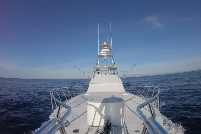  Yacht Photos Pics 2001 Hatteras 60 Convertible yacht cruising on open sea under clear blue sky.