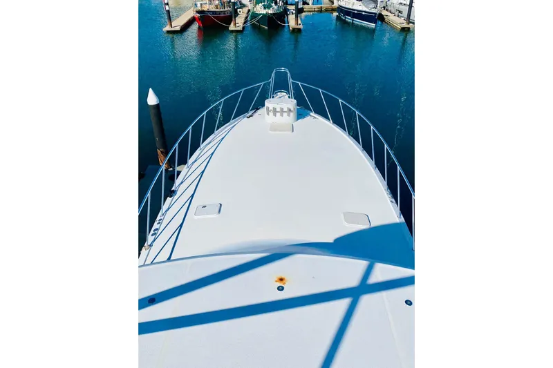  Yacht Photos Pics Bow view of 2001 Hatteras 60 Convertible yacht docked in marina.