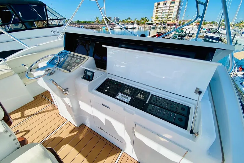  Yacht Photos Pics Control panel of a 2001 Hatteras 60 Convertible yacht in a marina setting.