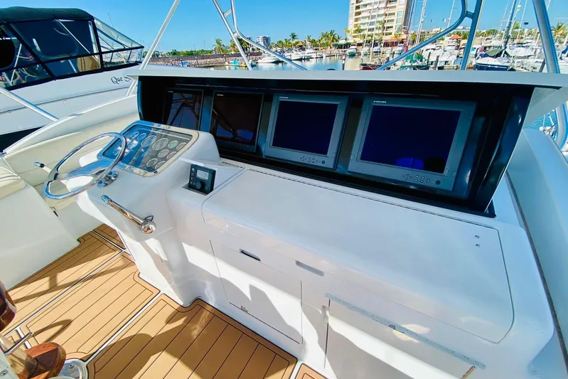  Yacht Photos Pics Helm of 2001 Hatteras 60 Convertible yacht with dual screens and wooden deck.