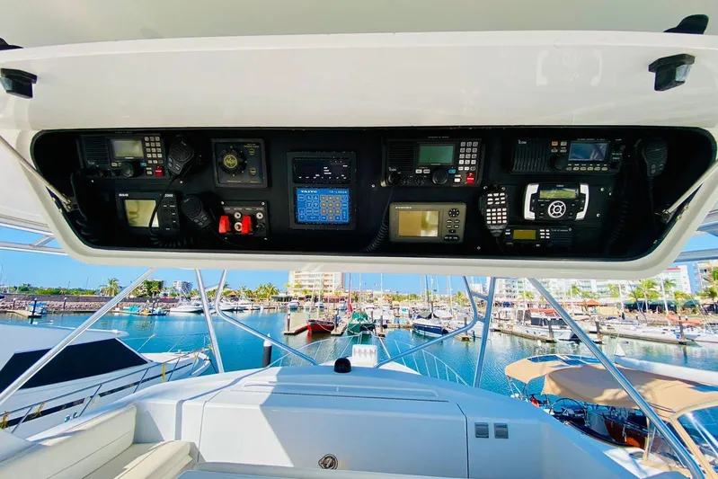  Yacht Photos Pics Control panel of a 2001 Hatteras 60 Convertible yacht overlooking a marina.
