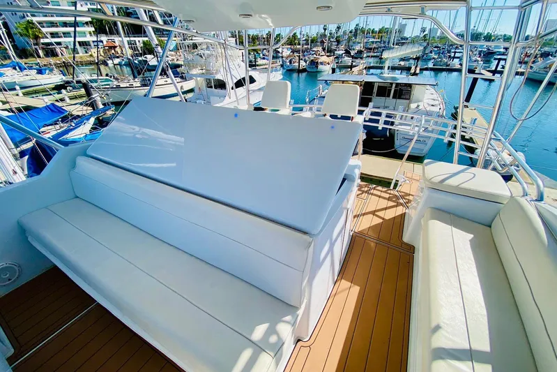  Yacht Photos Pics Luxurious 2001 Hatteras 60 Convertible yacht interior with white seating and marina view.