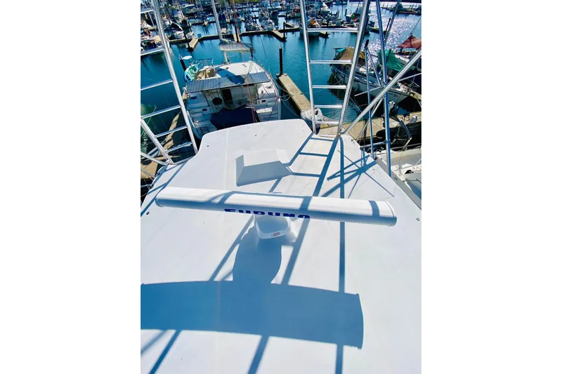  Yacht Photos Pics 2001 Hatteras 60 Convertible yacht with radar, docked in a marina.