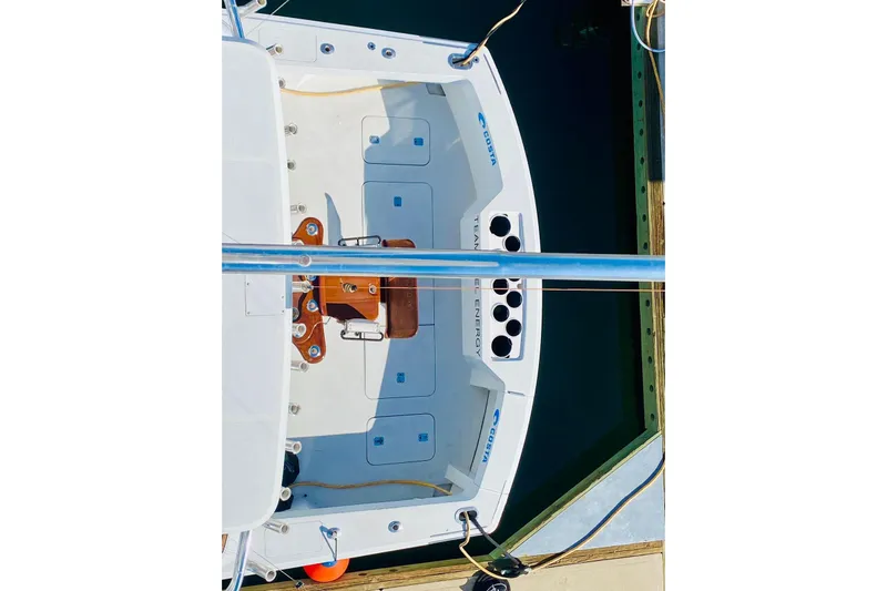  Yacht Photos Pics 2001 Hatteras 60 Convertible yacht deck view, featuring fishing rod holders and seating.