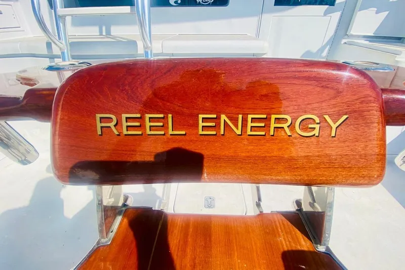  Yacht Photos Pics Wooden chair with "Reel Energy" engraved, aboard a 2001 Hatteras 60 Convertible yacht.
