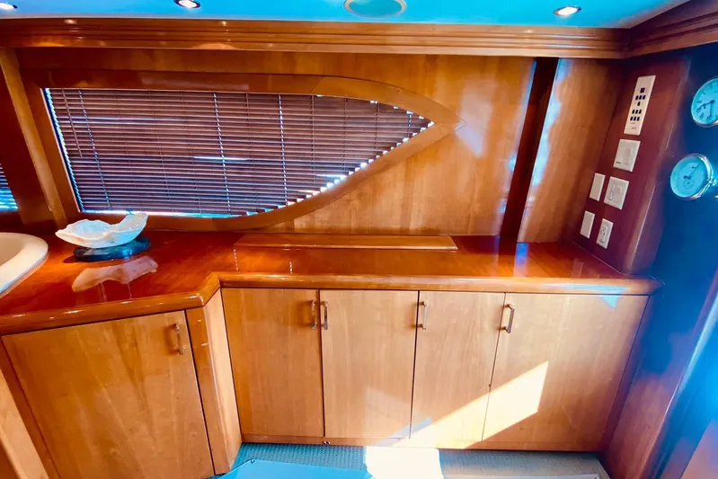  Yacht Photos Pics Luxurious wooden interior of a 2001 Hatteras 60 Convertible yacht with cabinets and blinds.