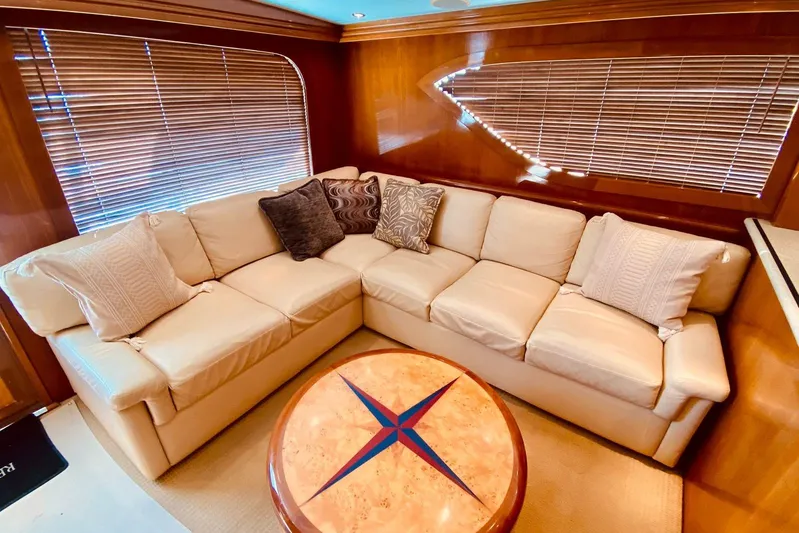  Yacht Photos Pics Luxurious interior of 2001 Hatteras 60 Convertible yacht with beige leather sofa and decorative pillows.
