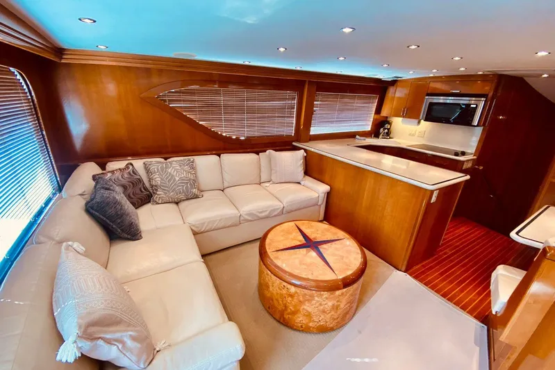  Yacht Photos Pics Luxurious interior of 2001 Hatteras 60 Convertible yacht with plush seating and modern kitchen.