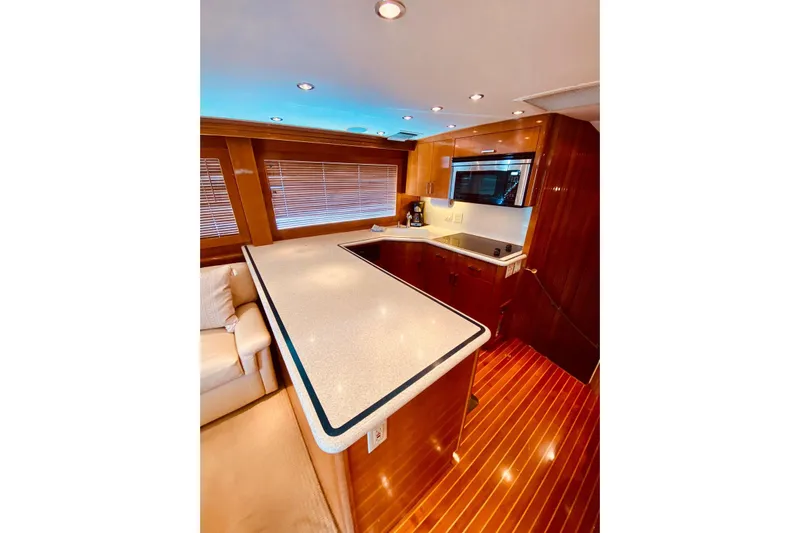  Yacht Photos Pics Luxurious kitchen interior of 2001 Hatteras 60 Convertible yacht with modern amenities.