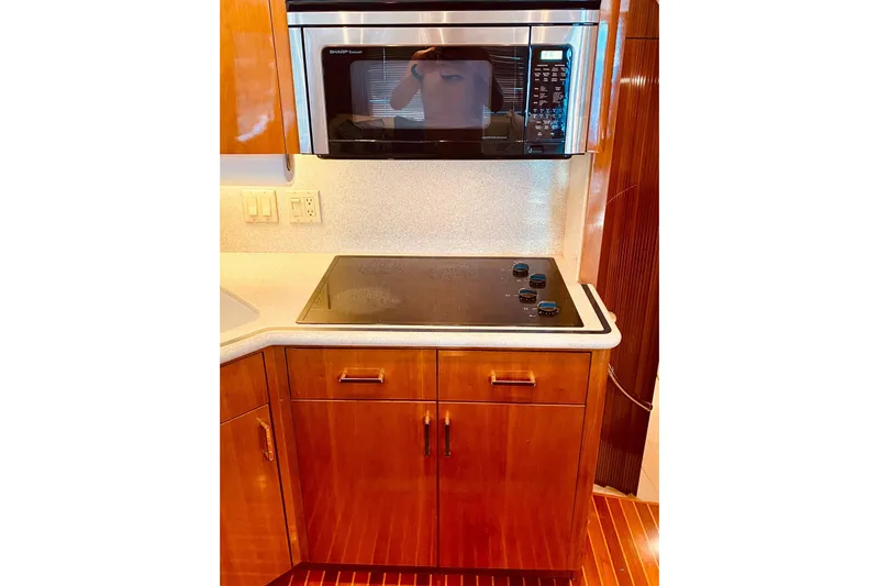  Yacht Photos Pics Kitchen area of 2001 Hatteras 60 Convertible yacht with stove and microwave.