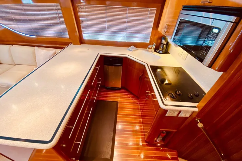  Yacht Photos Pics Luxurious kitchen interior of 2001 Hatteras 60 Convertible yacht with modern appliances.