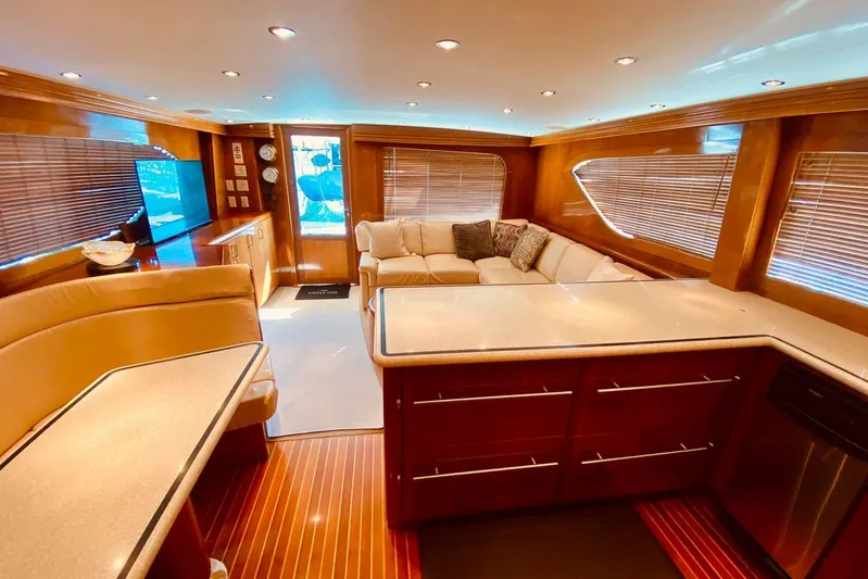 Yacht Photos Pics Luxurious interior of 2001 Hatteras 60 Convertible yacht with elegant wood finishes and plush seating.