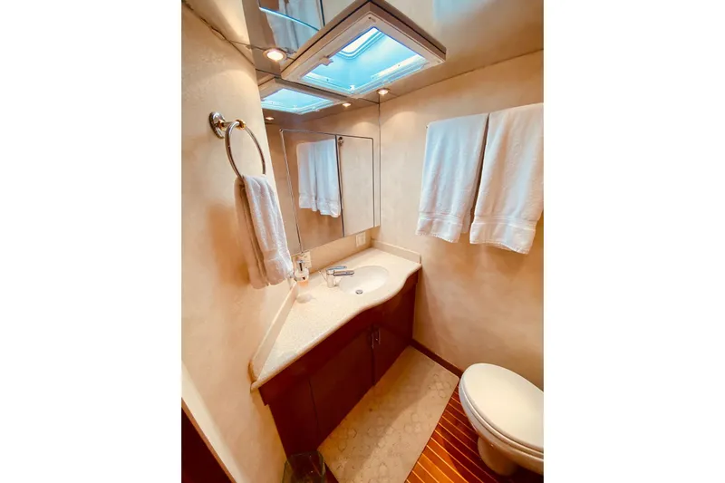  Yacht Photos Pics Luxurious bathroom in 2001 Hatteras 60 Convertible yacht with modern fixtures and elegant design.