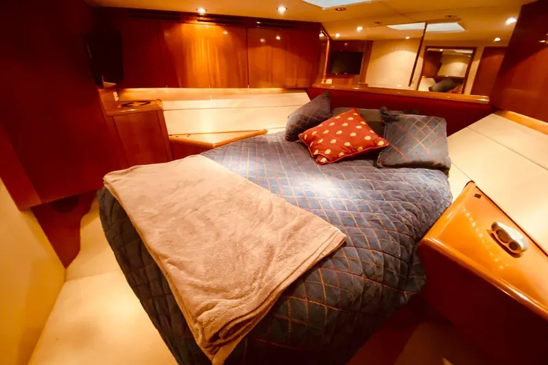  Yacht Photos Pics Luxurious cabin interior of 2001 Hatteras 60 Convertible yacht with cozy bedding.