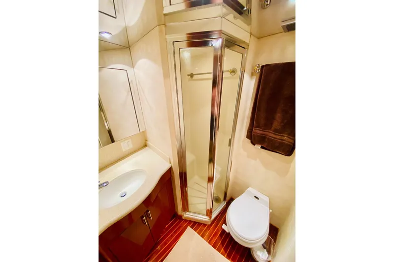  Yacht Photos Pics Luxurious bathroom in 2001 Hatteras 60 Convertible yacht with shower and toilet.