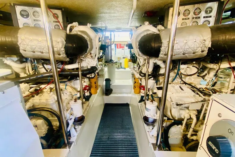  Yacht Photos Pics Engine room of 2001 Hatteras 60 Convertible yacht, showcasing dual engines and control panels.