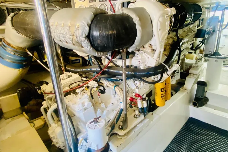  Yacht Photos Pics Engine room of 2001 Hatteras 60 Convertible yacht, showcasing detailed machinery components.