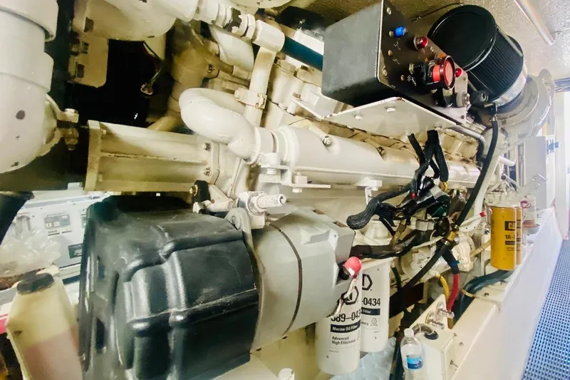  Yacht Photos Pics Engine room of 2001 Hatteras 60 Convertible yacht, showcasing mechanical components and filters.