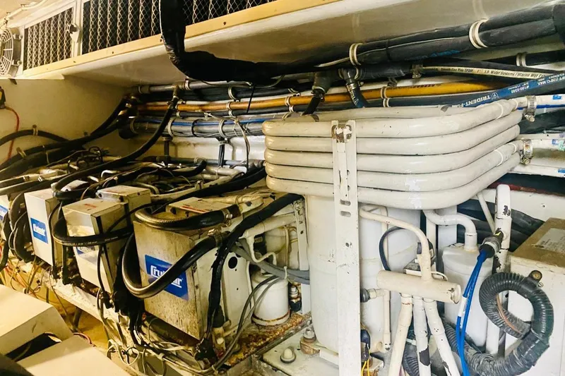  Yacht Photos Pics Engine room of 2001 Hatteras 60 Convertible yacht with complex piping and machinery.