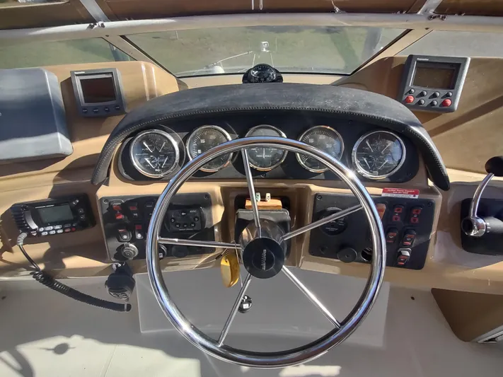  Yacht Photos Pics 2004 Carver 366 Motor Yacht helm with gauges, steering wheel, and navigation controls.