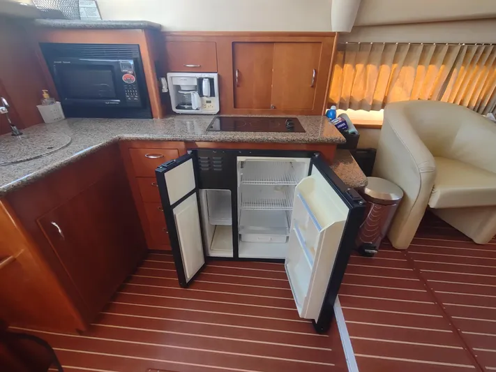  Yacht Photos Pics 2004 Carver 366 Motor Yacht kitchen with open fridge, microwave, and coffee maker.