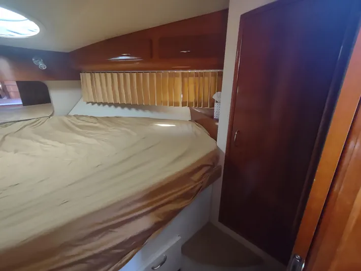  Yacht Photos Pics Interior cabin of 2004 Carver 366 Motor Yacht with bed and wooden accents.