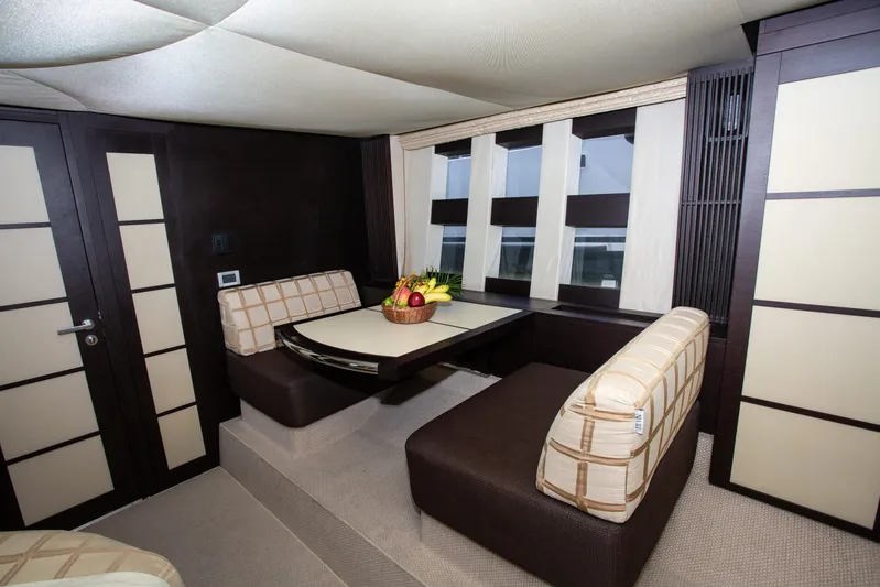  Yacht Photos Pics Luxurious dining area in 2008 Azimut 62S yacht with modern seating and fruit centerpiece.