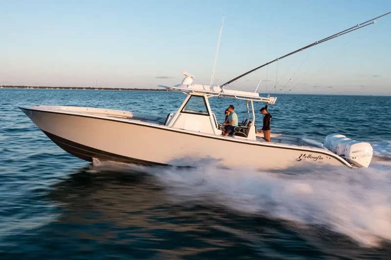 Yacht Photos Pics 2019 Yellowfin 39 Offshore boat cruising on open water at sunset.