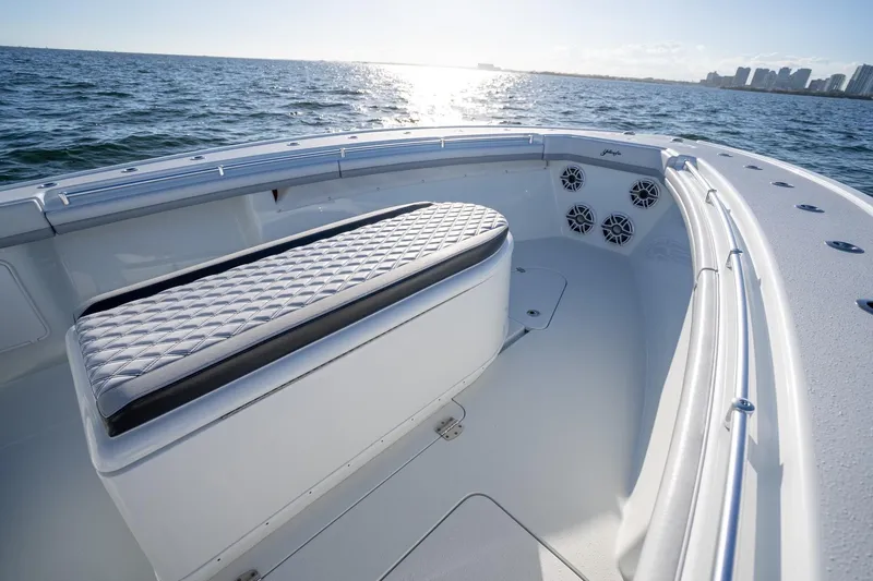  Yacht Photos Pics 2019 Yellowfin 39 Offshore boat interior with cushioned seating, ocean view, and city skyline.