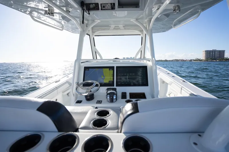  Yacht Photos Pics 2019 Yellowfin 39 Offshore boat dashboard with navigation screens on open water.