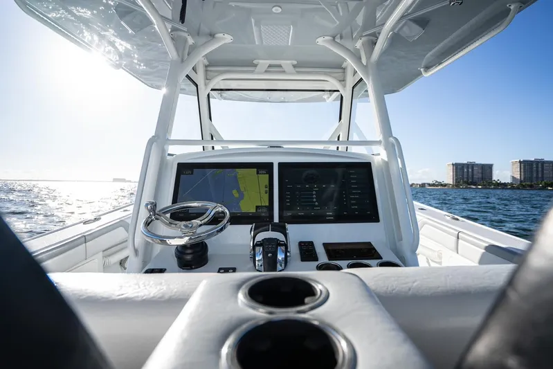  Yacht Photos Pics 2019 Yellowfin 39 Offshore boat cockpit with navigation screens and steering wheel.