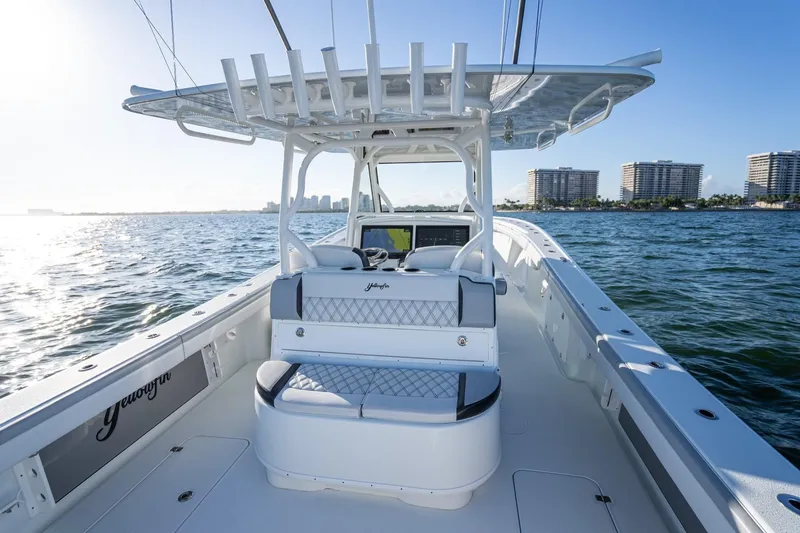  Yacht Photos Pics 2019 Yellowfin 39 Offshore boat on water, city skyline in background.