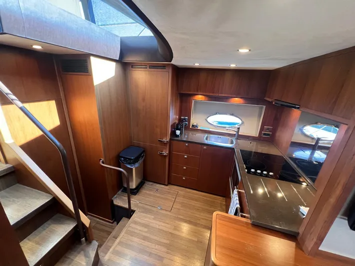  Yacht Photos Pics Luxurious kitchen interior of 2011 Princess V62 yacht with modern amenities and wooden finish.
