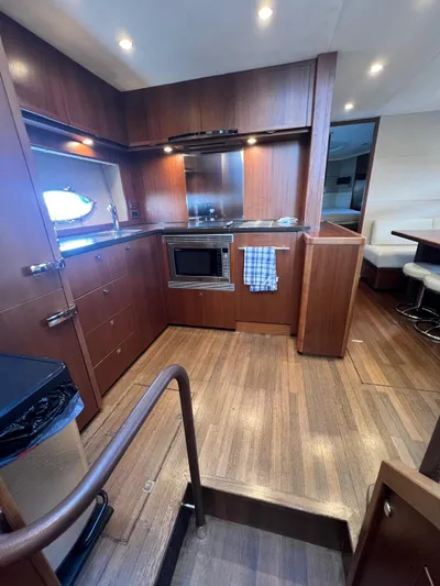  Yacht Photos Pics Luxurious 2011 Princess V62 yacht kitchen with wood cabinetry and modern appliances.