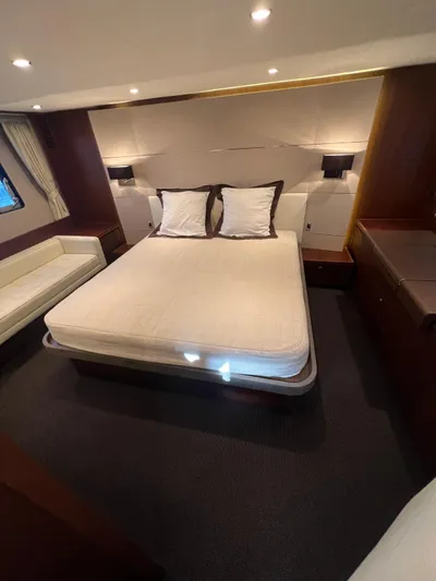  Yacht Photos Pics Luxurious bedroom interior of 2011 Princess V62 yacht with elegant bedding and ambient lighting.