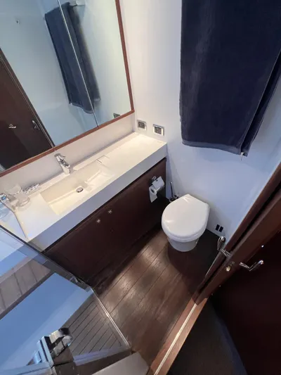  Yacht Photos Pics Luxurious bathroom in 2011 Princess V62 yacht with modern fixtures and wooden flooring.