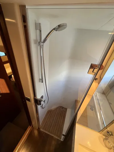  Yacht Photos Pics Shower area in 2011 Princess V62 yacht with wooden flooring and modern fixtures.
