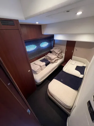  Yacht Photos Pics Luxurious cabin interior of 2011 Princess V62 yacht with twin beds and elegant wood paneling.