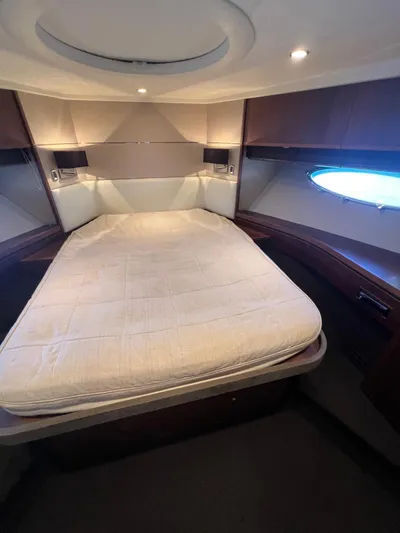  Yacht Photos Pics Luxurious cabin interior of 2011 Princess V62 yacht with cozy bed and ambient lighting.