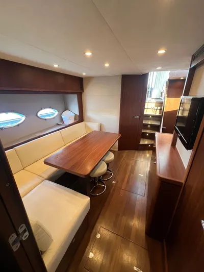  Yacht Photos Pics Luxurious interior of 2011 Princess V62 yacht with elegant seating and wooden finishes.