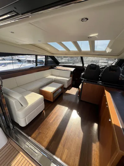  Yacht Photos Pics Luxurious 2011 Princess V62 yacht interior with white leather seating and wooden flooring.