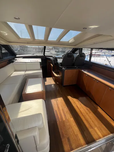  Yacht Photos Pics Luxurious interior of 2011 Princess V62 yacht with leather seating and wooden flooring.