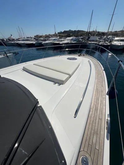  Yacht Photos Pics 2011 Princess V62 yacht deck with sunpad, docked in marina.