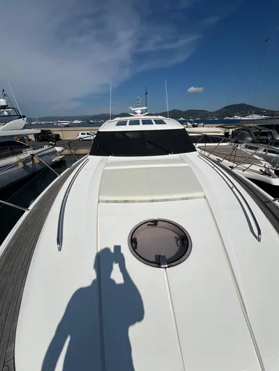  Yacht Photos Pics 2011 Princess V62 yacht docked at marina under clear blue sky.