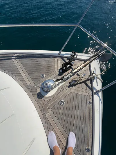  Yacht Photos Pics Bow of 2011 Princess V62 yacht with wooden deck and ocean view.