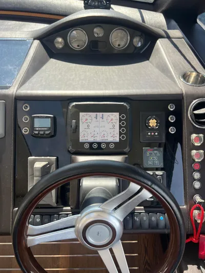  Yacht Photos Pics Control panel of a 2011 Princess V62 yacht with steering wheel and gauges.