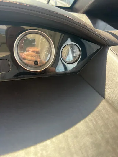  Yacht Photos Pics Dashboard of a 2011 Princess V62 yacht, featuring gauges and leather trim.