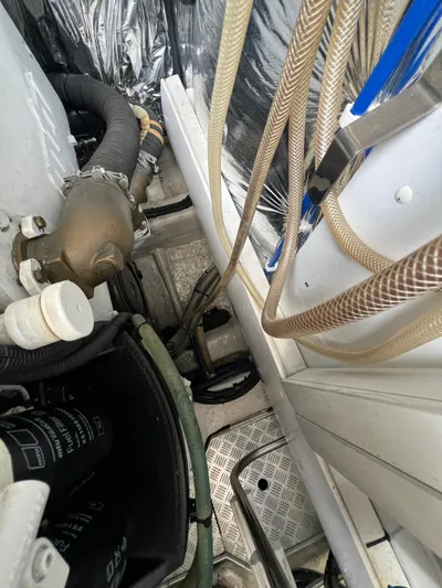  Yacht Photos Pics Engine room of a 2011 Princess V62 yacht, showing hoses and mechanical components.