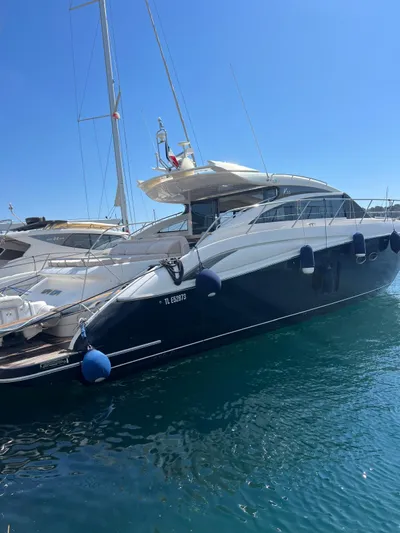  Yacht Photos Pics Luxury 2011 Princess V62 yacht docked in clear blue water.