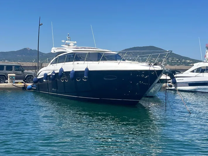  Yacht Photos Pics Luxury 2011 Princess V62 yacht docked in a scenic marina.